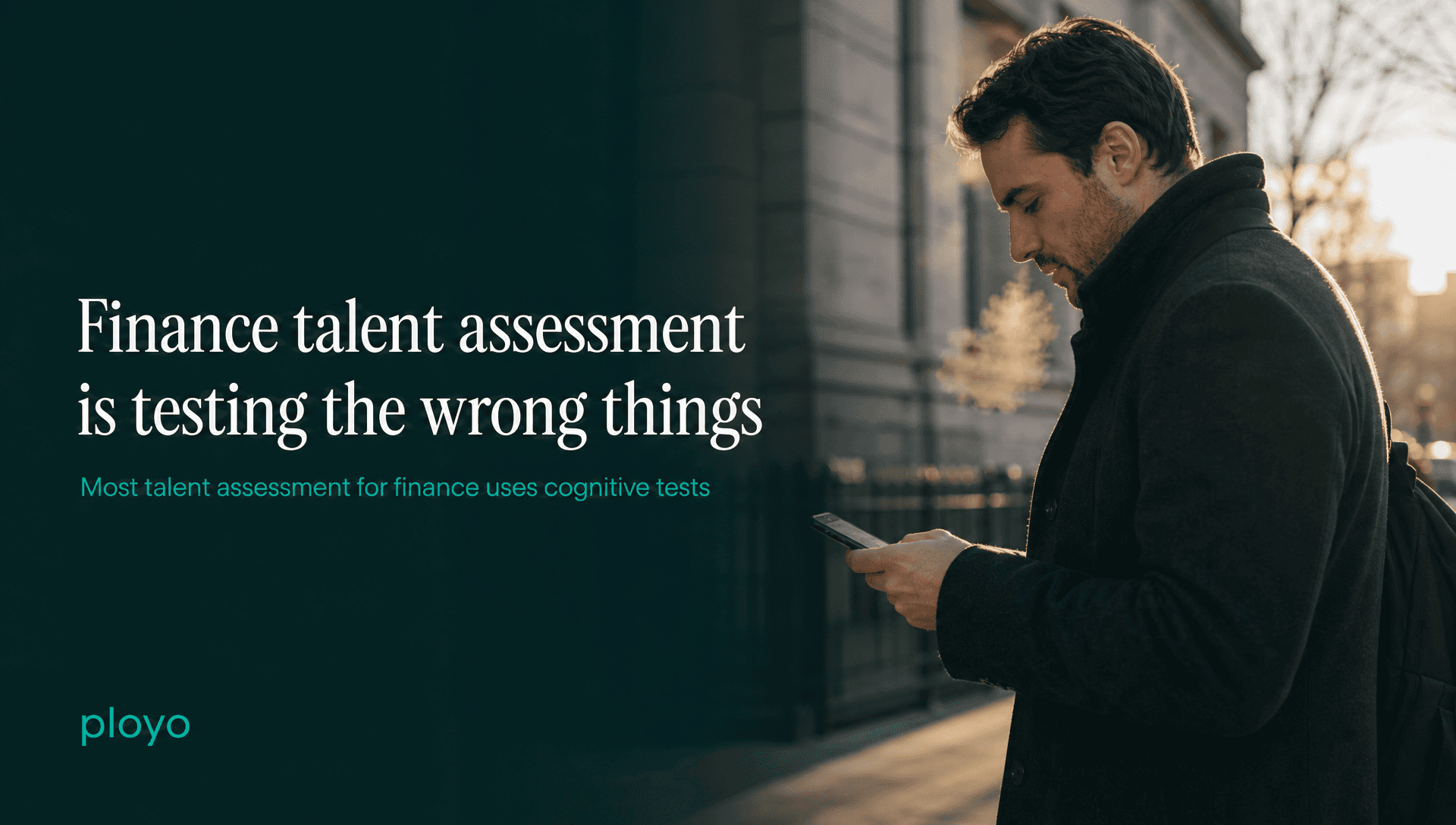 Someone standing outside a building in early morning light checking their phone, coat on, breath visible in the cold